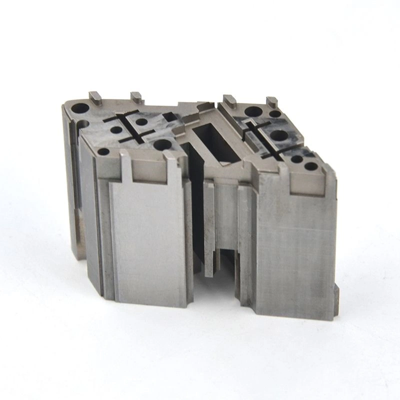 Complex precision machined metal block with multiple holes, recessed pockets and stepped side features